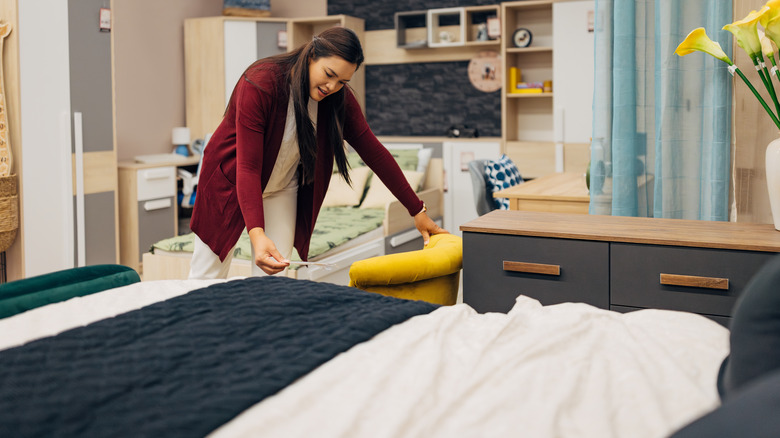 Woman browsing bedroom pieces at furniture store