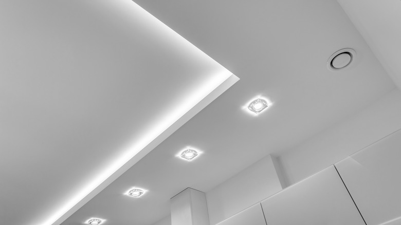 Row of overhead halogen lights in a neutral palette space