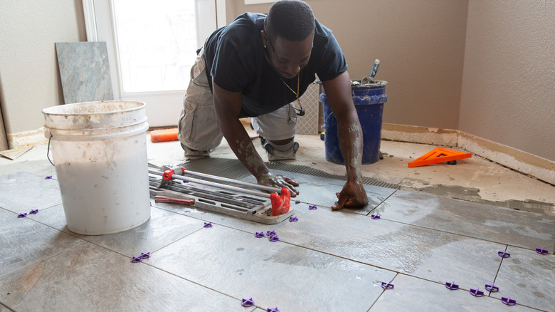 Someone installing tile