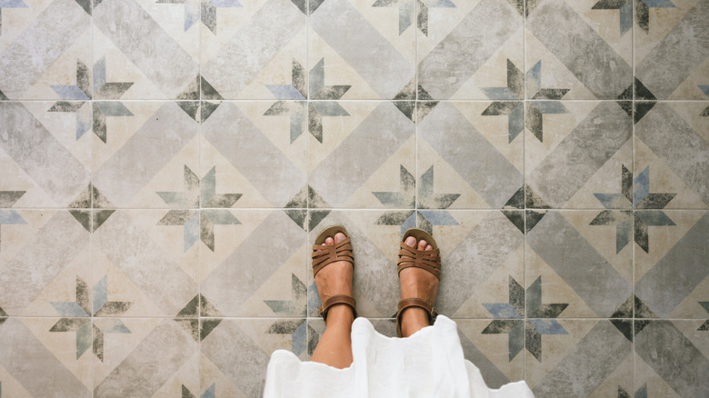 Someone standing on a patterned floor