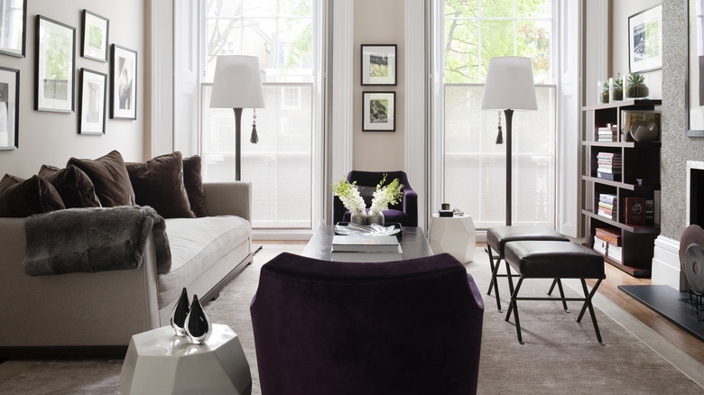 Elegant living room with white sofa with two accent chairs on either side