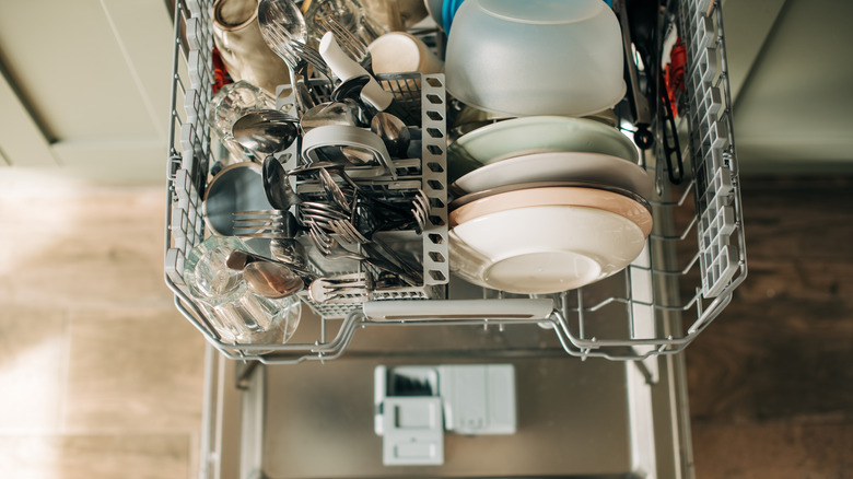 Clean, dry dishes on the bottom drawer of a dishwasher