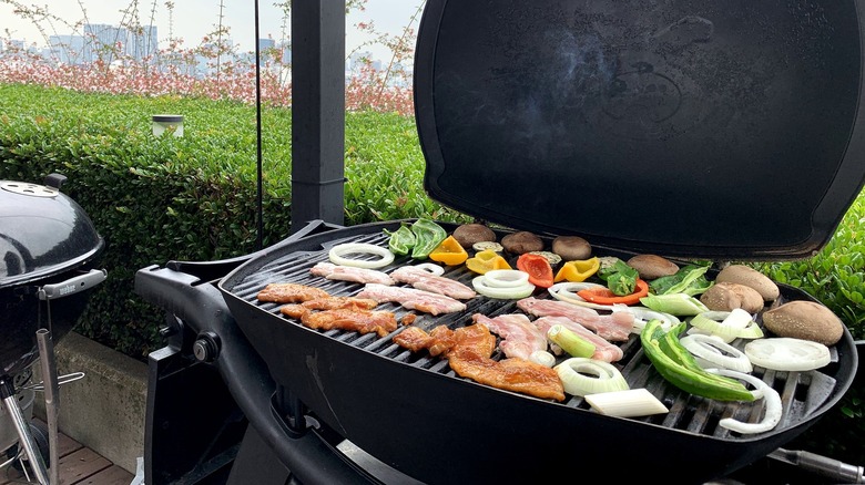 Vegetables, mushrooms, and meat on a grill