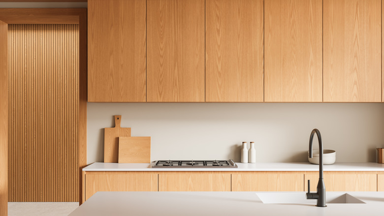 A minimalist kitchen with blond wood cabinets