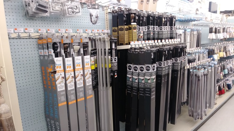 Curtain rods, including tension rods, for sale at a store