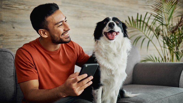 man with dog on couch