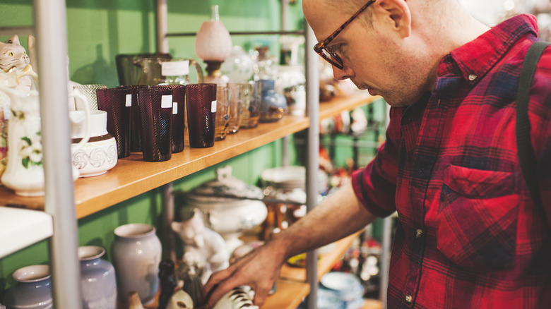 Someone shopping for decor in a thrift store