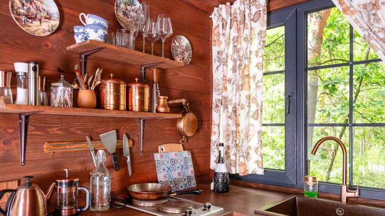 Vintage kitchen decor shelves with fine chinaware and copper canisters