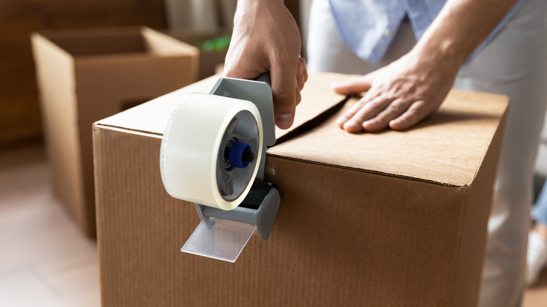 Person using clear packing tape
