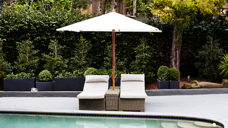 poolside umbrella with seats