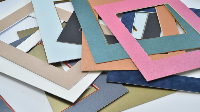 A variety of colored photo mats scattered on a table
