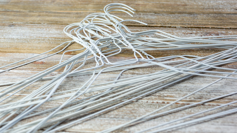 Pile of white wire hangers.