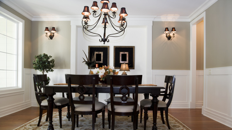 Wainscoting below beige painted walls in a dining room