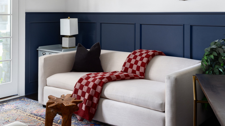 Blue Wainscoting in a living room, behind a beige couch
