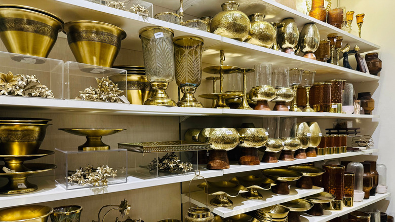 Brass items lined up on a store shelf