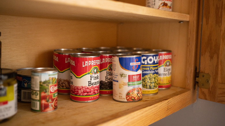 Canned food in kitchen cabinet 