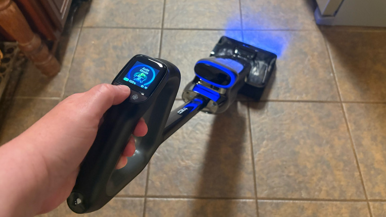 A Tineco Floor One S9 Artist Steam Series Smart Cordless Steam Floor Washer is used in Auto Mode on neutral tile floors