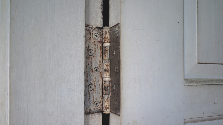 A rusty hinge on a door
