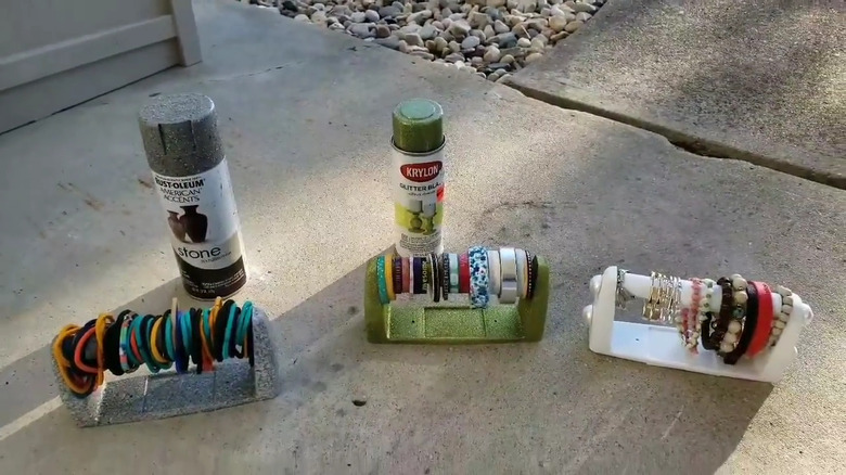 Woman demonstrating how to turn a toilet paper roll holder into an organzier for hair ties, etc.
