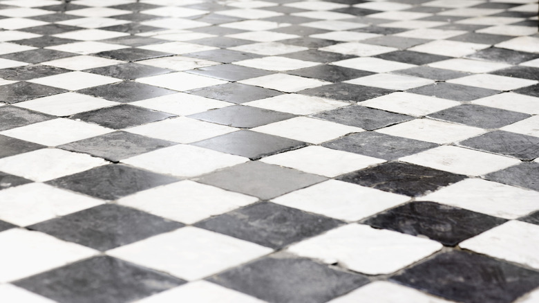 Close-up of scratched checkered tile flooring