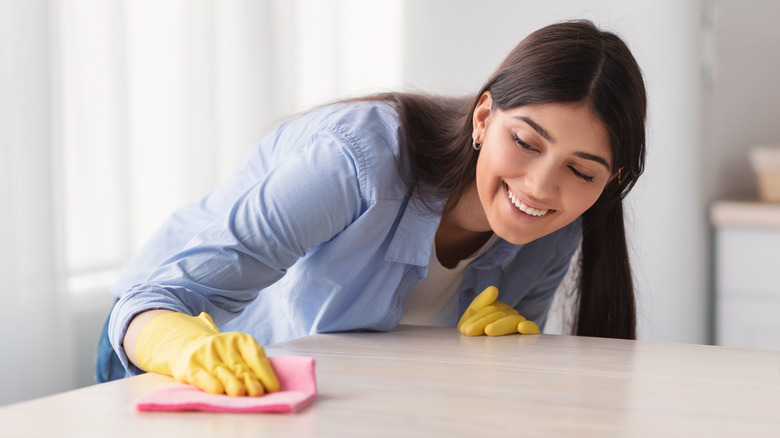 Woman scrubbing countertop