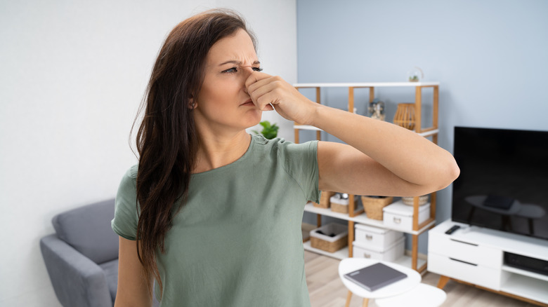 woman pinching nose
