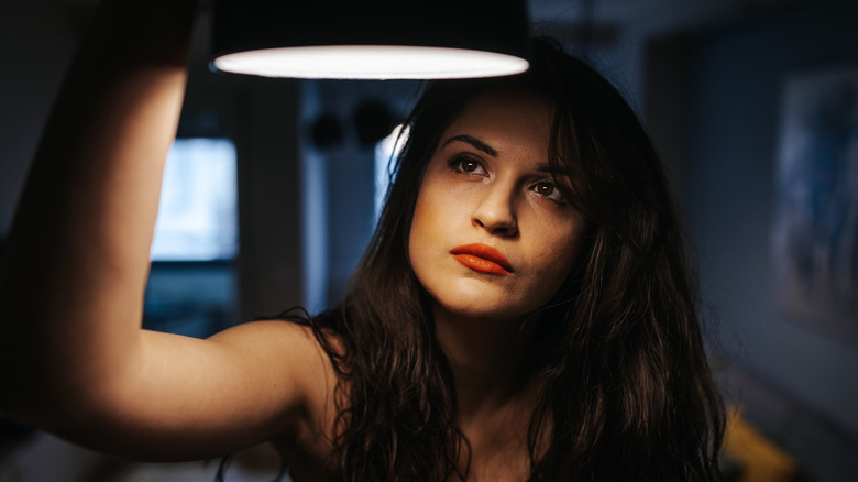Woman looking at lamp
