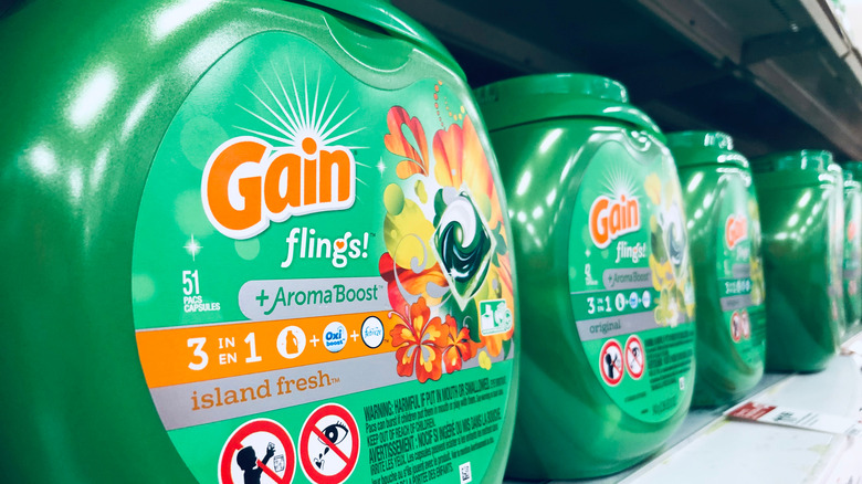 Containers of Gain laundry pods on a store shelf