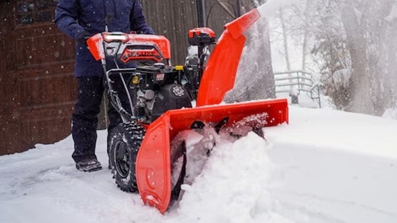 Person using an Ariens snow blower