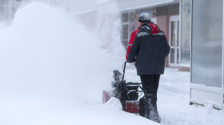Person using a two-stage snow blower