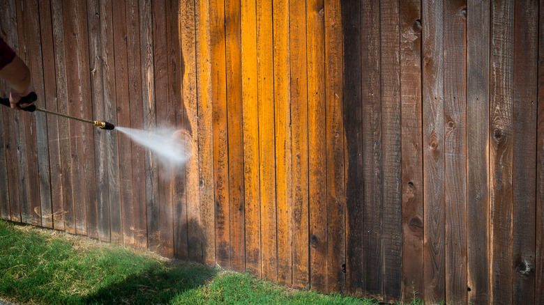 pressure washer cleaning wooden fence