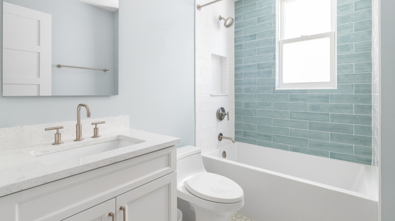A clean bathroom focused on the tub, toilet, and sink