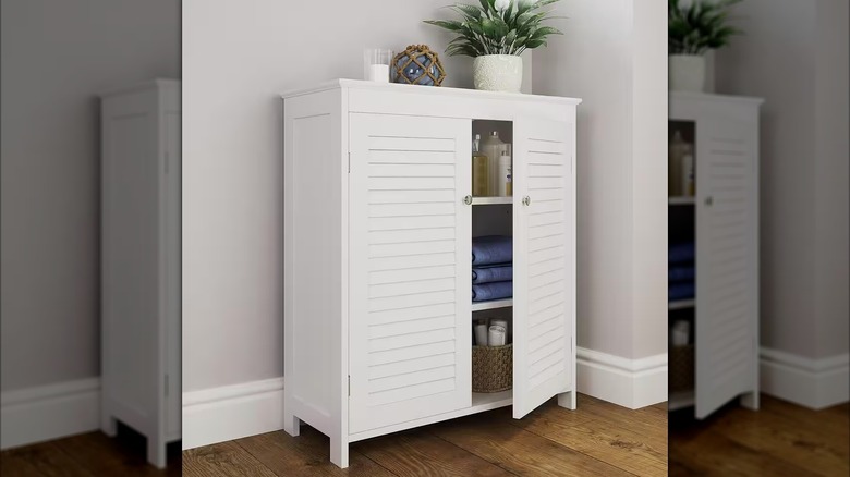 Bathroom towels stored inside a white cabinet.