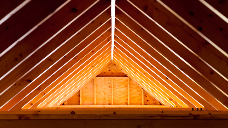 A wooden roof frames and trushes in an attic space