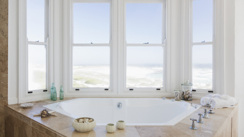 Bare bay window in coastal bathroom overlooking the beach