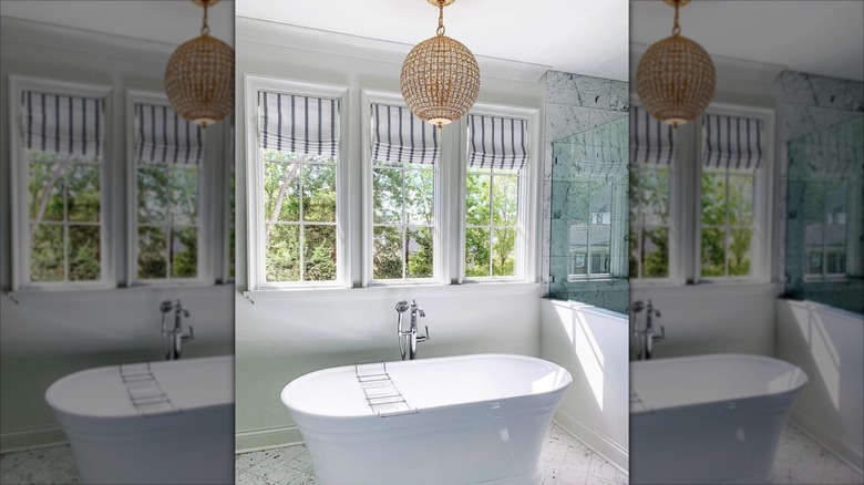 Bathroom with gray and white striped roman shades