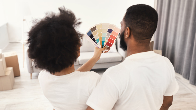 couple choosing wall paint color