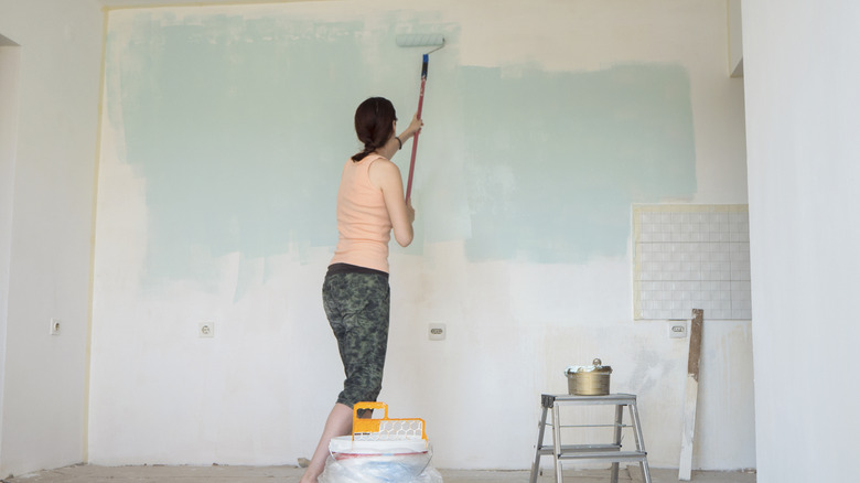 woman painting wall