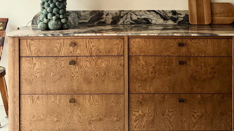Burl wood cabinet with back and white marble countertop