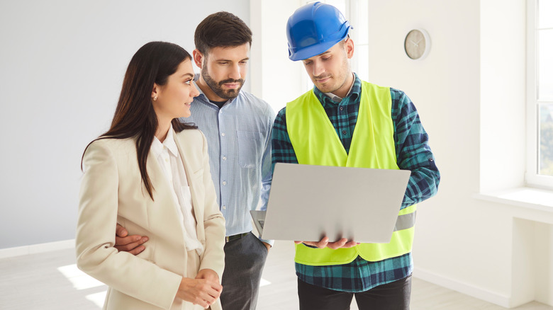 A couple discussing design ideas with a contractor