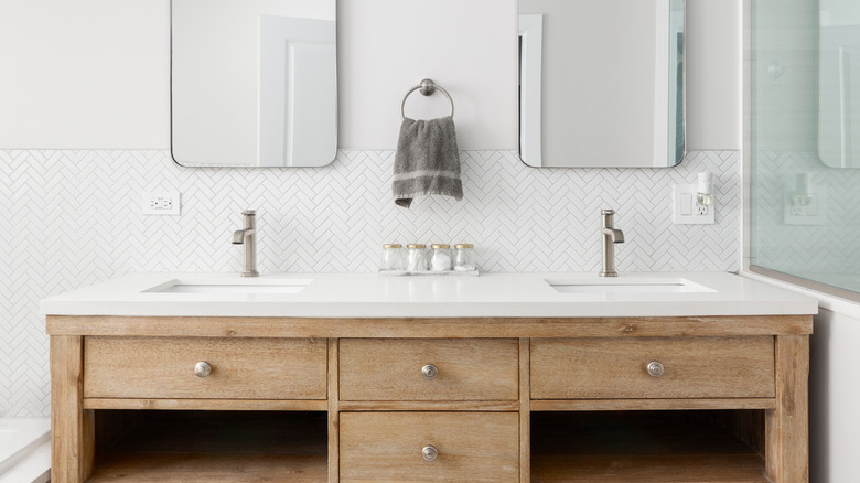 Bathroom with wood cabinets, white countertop and silver hardware