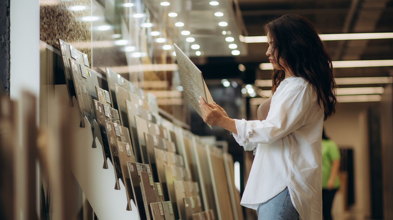 a woman looking at tile options at the store