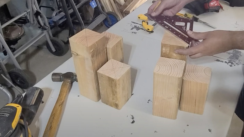 person measuring wood blocks