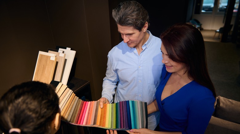 A couple looking at upholstery color samples