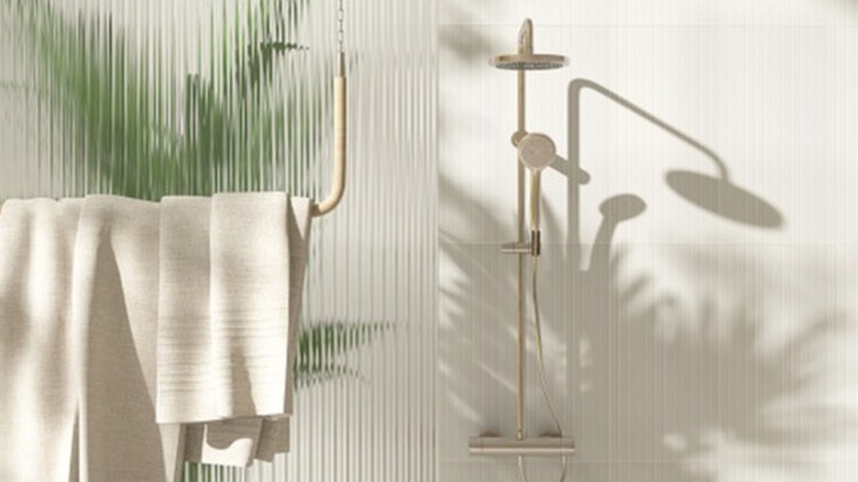 Fluted shower glass with a towel hanging in front of it