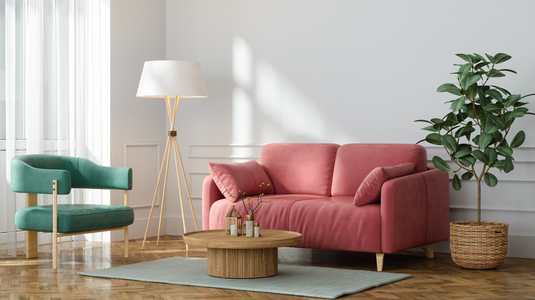 Pink couch with wood and green accents