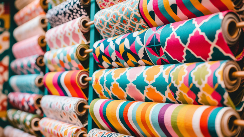 rolls of bright patterned fabrics