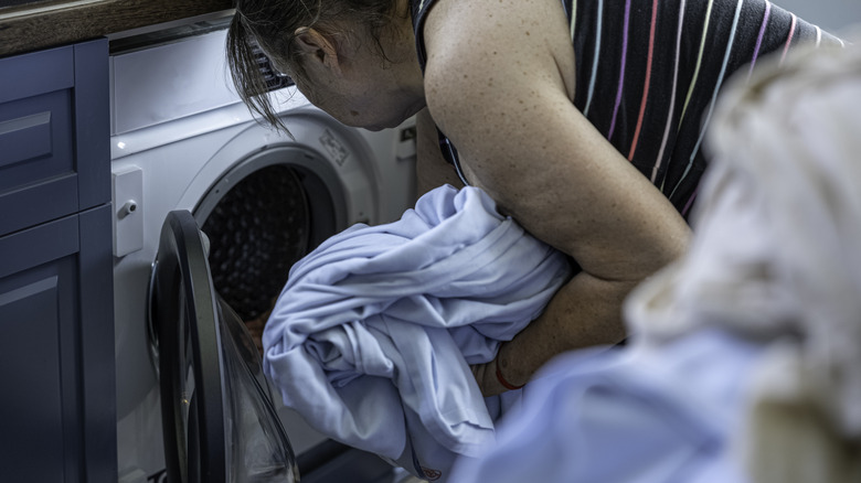 Person loading a clothes dryer