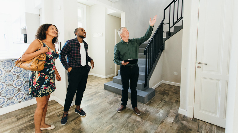 Couple touring house with realtor