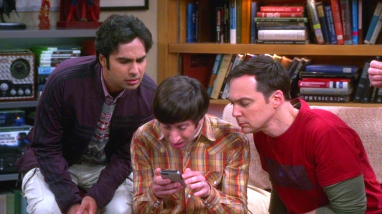 Raj, Howard, and Sheldon staring at a screen in the Big Bang Theory apartment